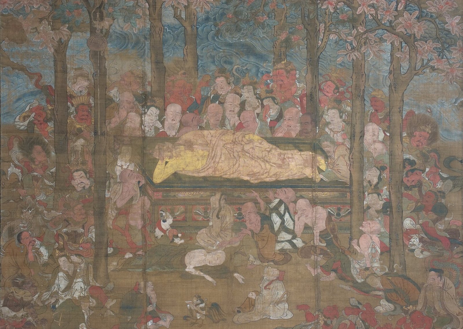 A Japanese hanging scroll: the Buddha, robed in gold, lies on a dais under blossoming sala trees while monks, gods and animals crowd around him, many of them weeping or collapsed in grief